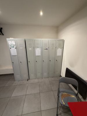a room with lockers and a red table in it