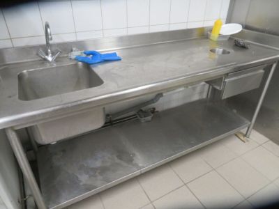 a stainless steel sink in a commercial kitchen