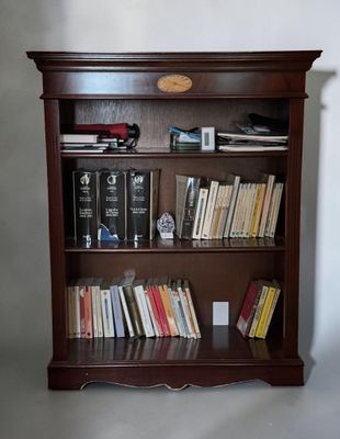 a bookshelf with a bunch of books on top of it