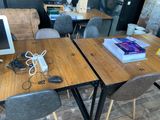 two desks with computers on them in a room