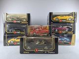six toy cars are in a box on a white surface