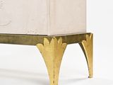 a white box sitting on top of a gold stand