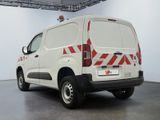 a white van with red and white stripes parked in a garage