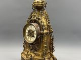 an image of a gold clock sitting on top of a table