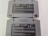 two nintendo game cartridges sitting next to each other on a table