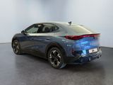 the rear end of a blue electric car in a showroom