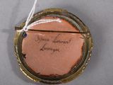 a picture of a small piece of jewelry with writing on it