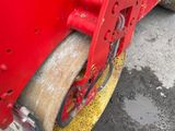 a close up of a road roller on the ground
