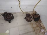 two gas stoves that are on the floor in the bathroom