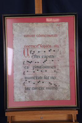 a framed picture of a music score on a easel