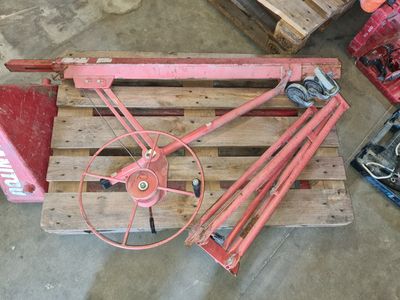 a wooden pallet with a red wheel on top of it