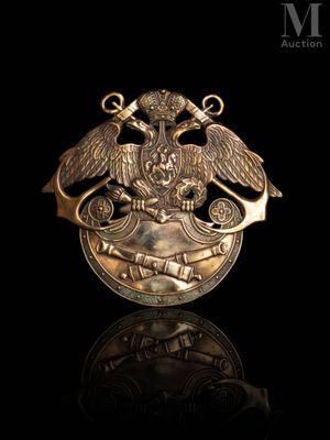 a close up of a gold medal with two birds on it