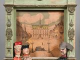 two dolls that are sitting in a picture frame