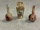 three vases sitting next to each other on a table