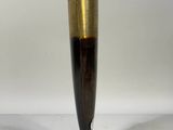 brown and gold vase on a white surface with a white background
