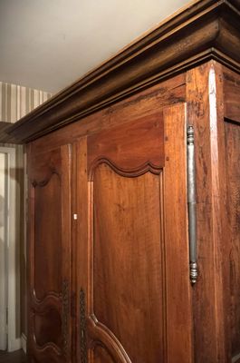 a wooden armoire with a mirror on top of it