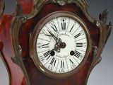 a wooden clock with roman numerals on the face