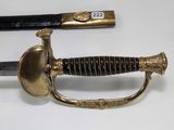 an image of a sword with a gold handle and a black handle