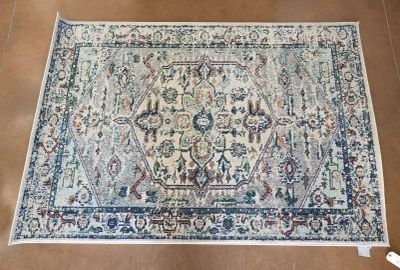 a close up of a rug on a wooden floor