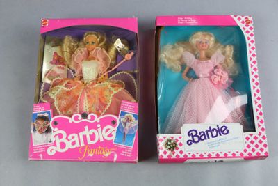 two barbie dolls in the box on the table