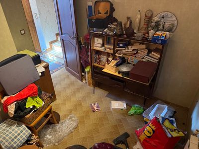 a view of a messy living room with a lot of clutter on the floor