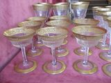 a lot of wine glasses sitting on a pink table