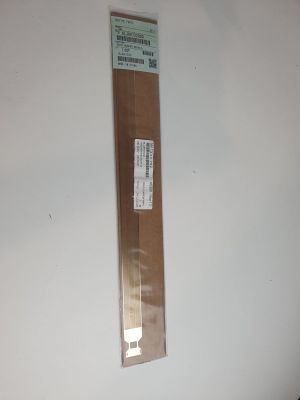 a piece of cardboard on the wall with a sticker attached to it