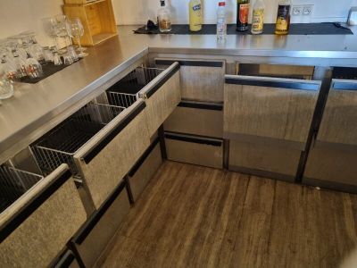 a stainless steel kitchen with a sink and a dishwasher