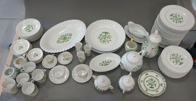 many plates and cups and bowls on the table