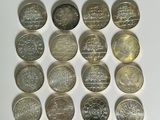 a lot of coins that are on a white surface