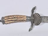 a knife with a wooden handle on a white surface