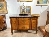 a marble top cabinet with a clock on top