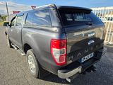 the back end of a grey pick up truck parked in a parking lot