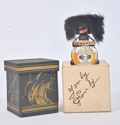 a small stuffed animal sitting on a box next to a box