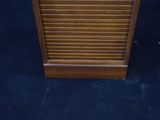 a small wooden cabinet with a clock on top of it