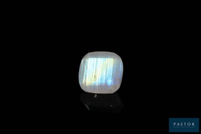 a white oplite stone on a black surface