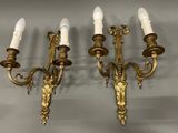pair of antique brass wall sconces with white candles