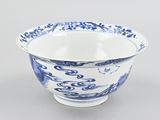 a blue and white bowl with a bird design on it