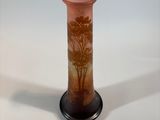 a glass vase that has a picture of a tree on it