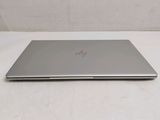 the laptop is sitting on a white surface with a white background