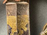 a close up of a knife with a bird on it
