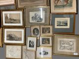 many framed pictures on the wall of this room