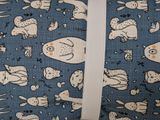 a blue bag with a pattern of cats and dogs on it