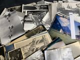 a pile of old black and white photos on a table