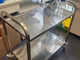 a metal cart with bottles on it in a lab