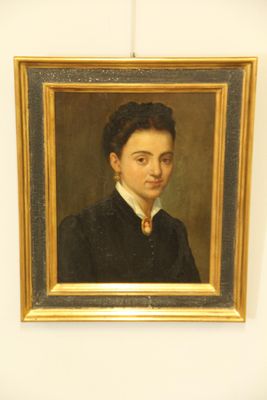 portrait of a young man in a black coat and a yellow tie