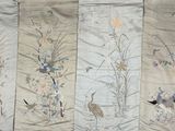 four panels of fabric with birds and flowers on them