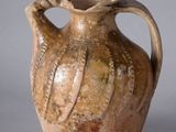 a brown vase that is sitting on a table