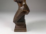 statue of a woman holding a flower in her hand