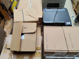 a pile of boxes and a laptop on a pallet